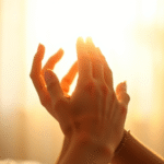 Gentle hands reaching toward light beam, soft healing energy, peaceful rehabilitation setting, warm golden tones, no text no words no letters