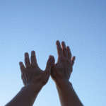 Soft lighting gentle hands reaching toward calm blue sky peaceful healing journey mental wellness no text no words no letters