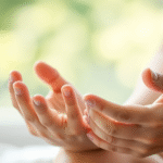 Gentle hands supporting child development, soft natural lighting, peaceful therapy environment, calming blues and greens, no text no words no letters