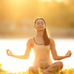 Peaceful person meditating in soft golden sunlight with serene natural background, calm contemplative mood, no text no words no letters