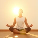Person sitting in peaceful meditation pose in bright natural light, serene expression, mindful breathing, warm golden hour lighting, minimalist clean background, photorealistic, calm atmosphere