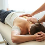 Chiropractor performing spinal adjustment on patient lying face-down on treatment table, hands-on technique, clinical setting, professional healthcare environment, soft lighting, focus on spine alignment