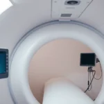 Professional medical hyperbaric chamber interior showing pressurized white cylindrical tube with medical monitoring equipment, soft clinical lighting, no text visible